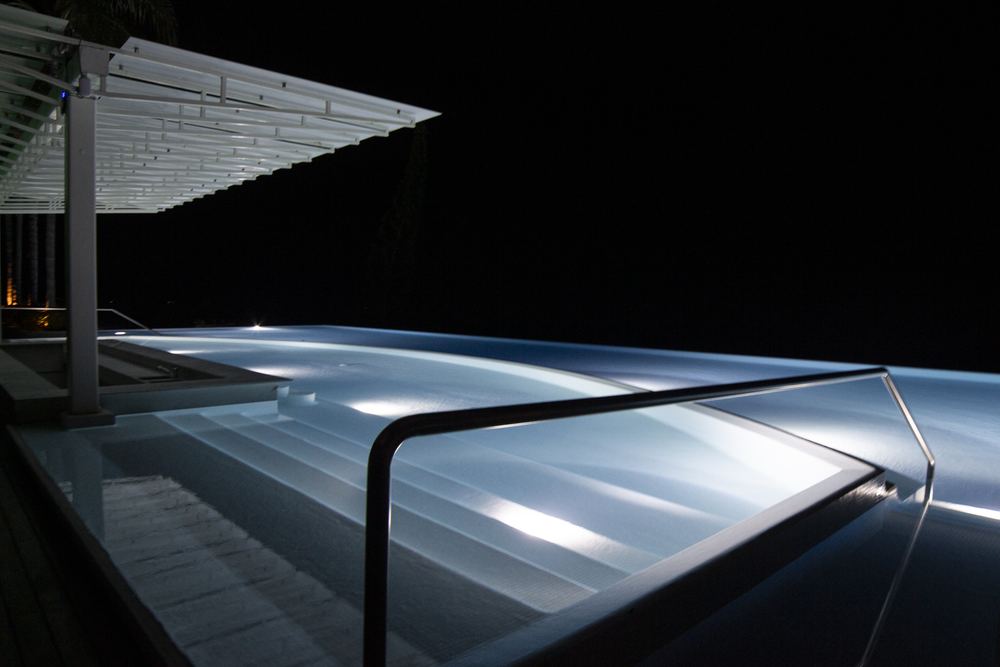 Rooftop pool illuminated at night