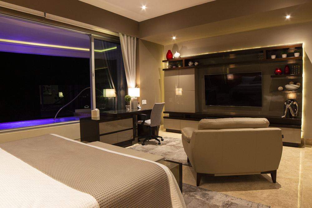 Master bedroom with pool view at night